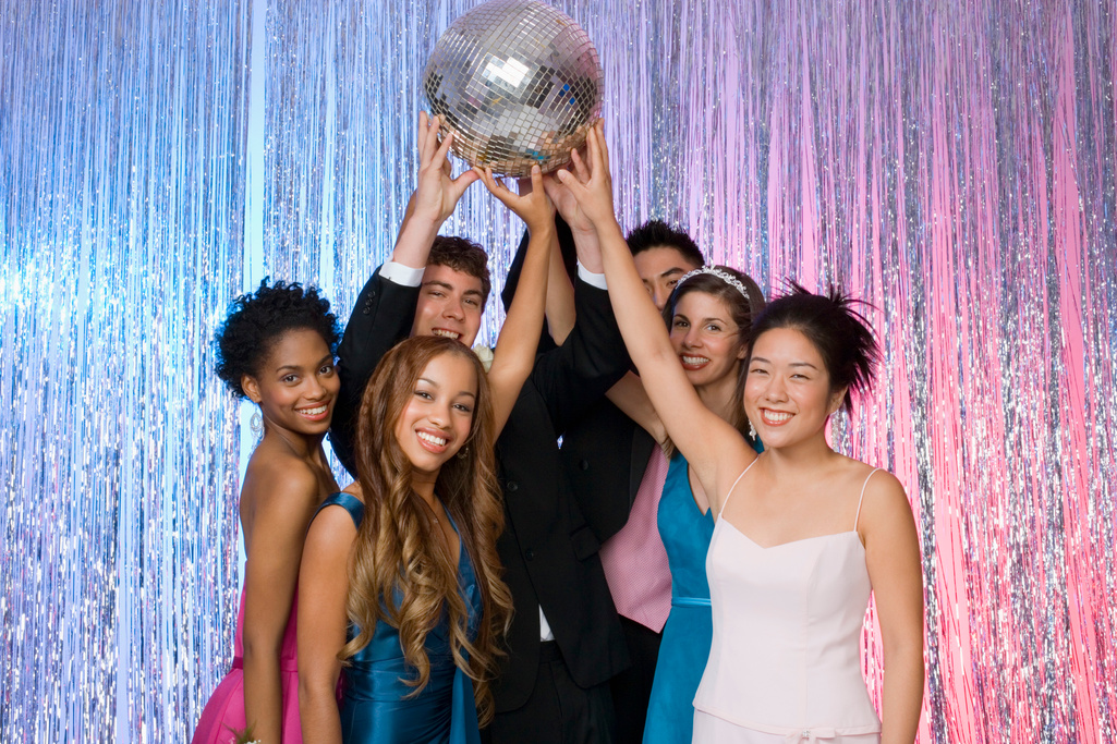 Teens at prom holding up disco ball